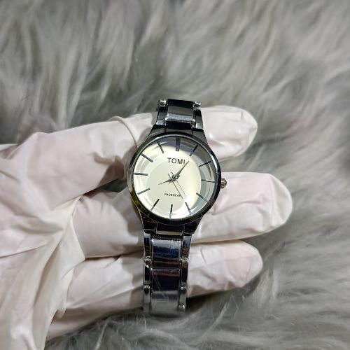 Modern TOMI couple watch set with silver-tone stainless steel band, minimalist dial, and classic unisex style.