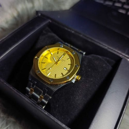 Elegant Audemars Piguet Royal Oak men’s timepiece featuring gold bezel, stainless steel bracelet, and yellow tapisserie dial.
