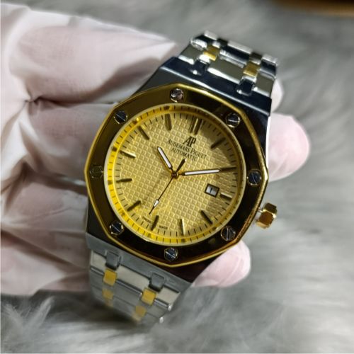 Stylish Audemars Piguet Royal Oak watch with dual-tone bracelet, golden bezel, and textured yellow dial with date window.