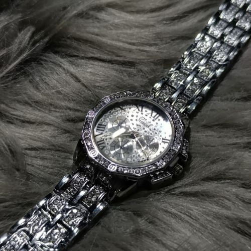 Close-up of Roman numeral dial on elegant diamond women’s wristwatch