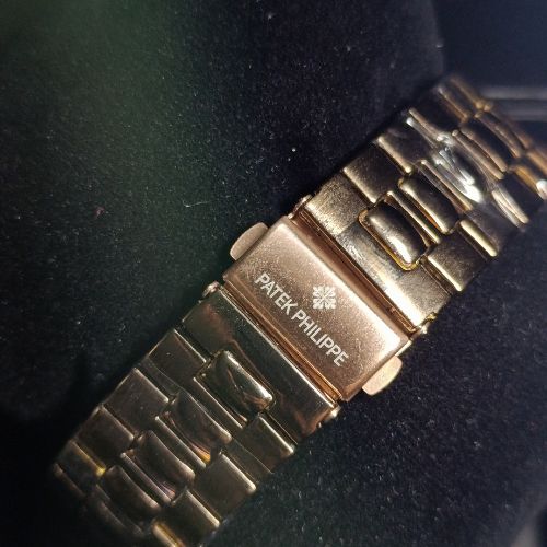 Feminine Patek Philippe Nautilus women’s rose gold watch featuring diamond bezel, crystal accents, and moonphase subdial.