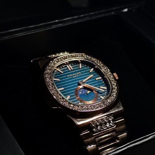 Premium Patek Philippe Nautilus ladies’ timepiece in rose gold with diamond bezel and moonphase subdial on a blue dial.