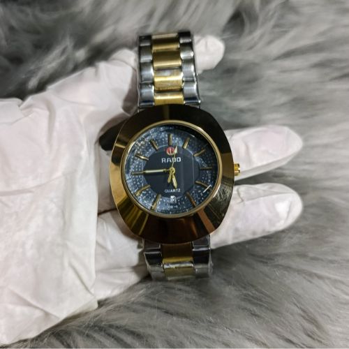 Timeless Rado DiaStar men’s watch with black dial, quartz accuracy, and polished gold stainless steel bracelet.
