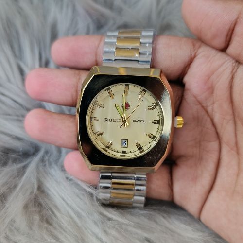 Close-up of gold-tone dial with luminous markers and octagonal case