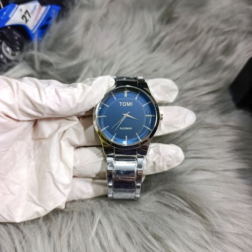 Stylish TOMI couple watch set featuring durable stainless steel straps and modern blue dial design for men and women.