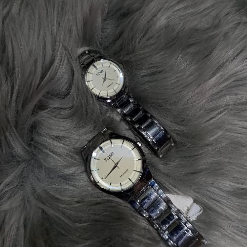 Stylish TOMI matching watches for couples featuring polished silver bracelet straps and clean white dial.