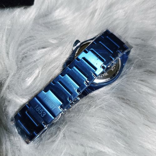 Close-up of black textured dial on Tissot PRX 1853 all blue men’s quartz watch