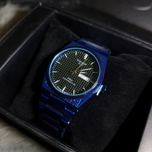 Side angle of Tissot PRX 1853 all blue men’s watch showing stainless steel strap