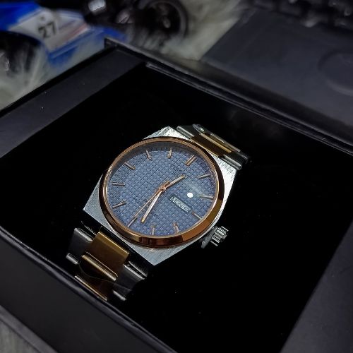 Side profile of Tissot PRX 1853 Day & Date Watch with stainless steel chain bracelet