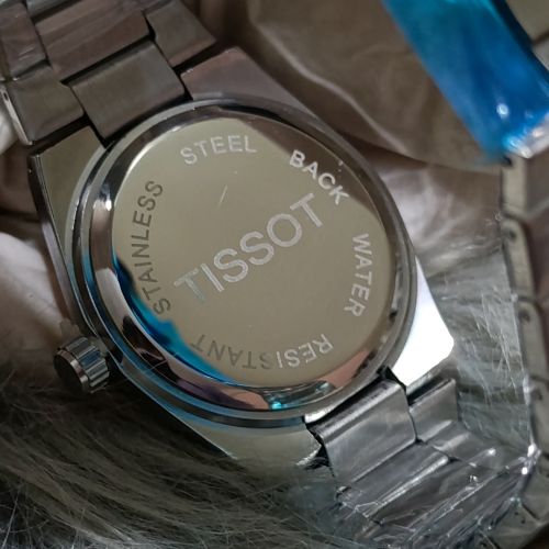 Tissot PRX 1853 Day & Date Watch worn on wrist in formal wear style