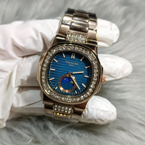 Stylish women’s Patek Philippe Nautilus rose gold watch with diamond-studded bezel, bracelet links, and moonphase design.
